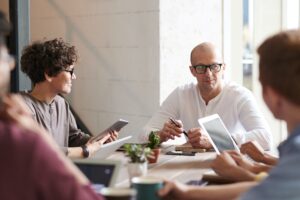 Day time focus group sits at table having a discussion.