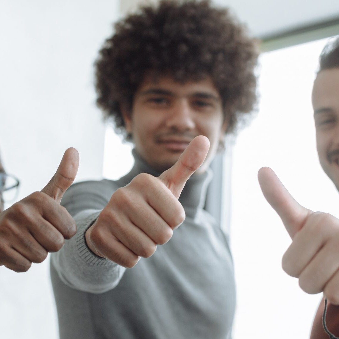 3 men giving a thumbs up for successful qualitative research