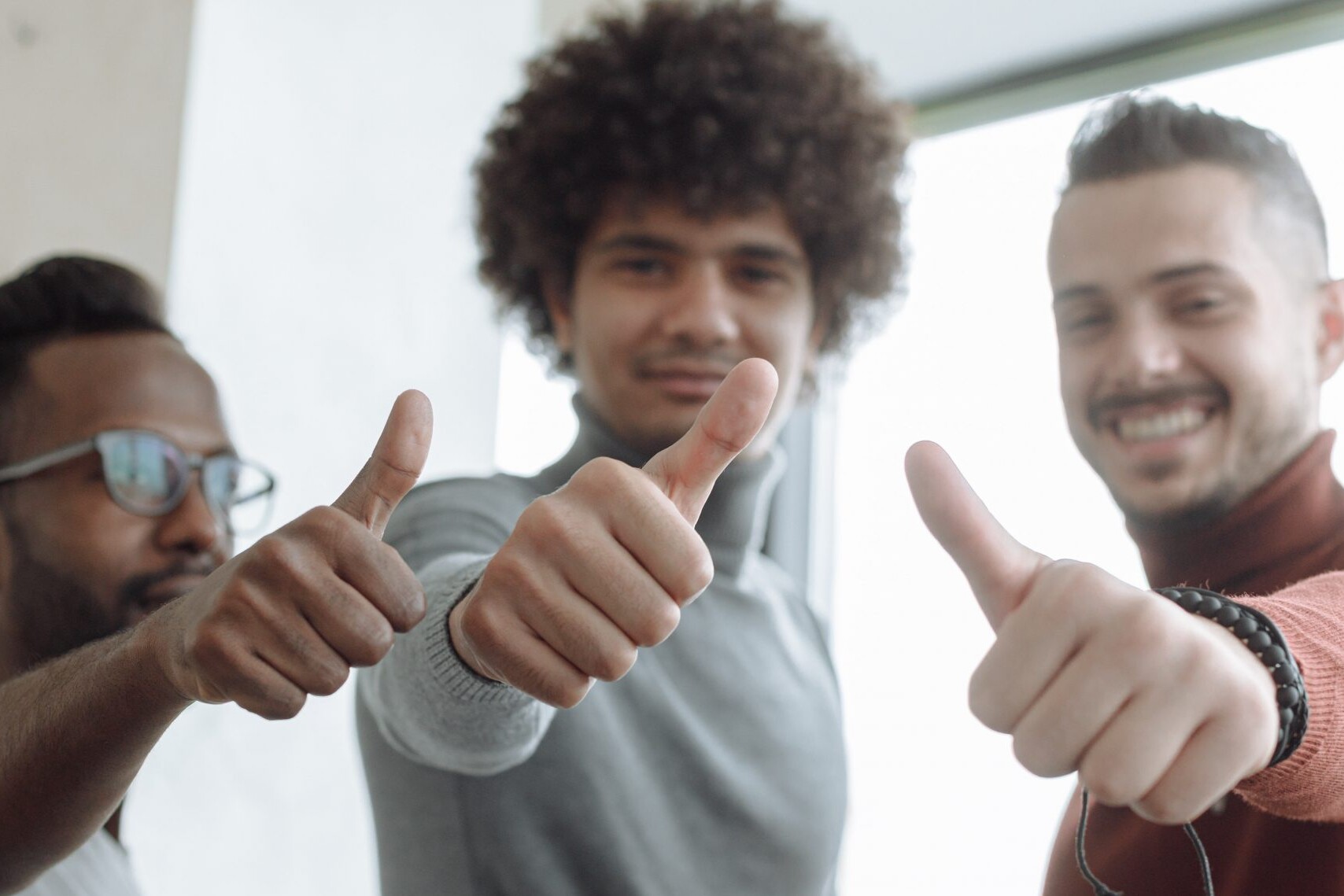 3 men giving a thumbs up for successful qualitative research